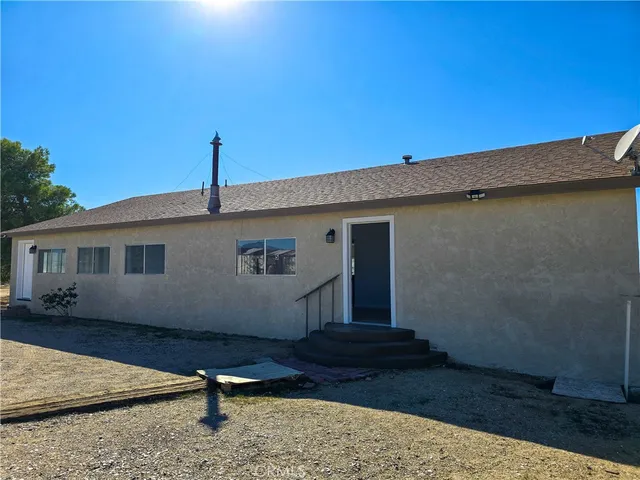 a house view with a backyard space