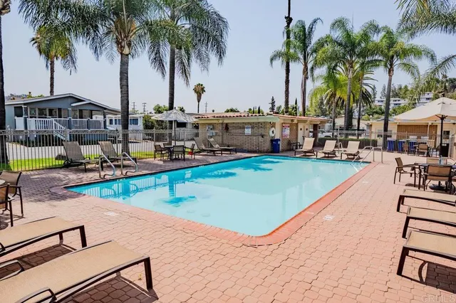 a view of swimming pool with outdoor seating and a patio