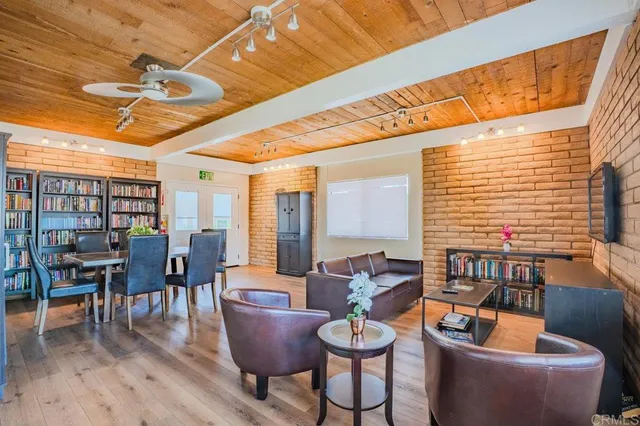 a dining room with furniture window and wooden floor