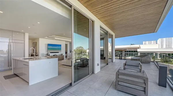 a view of a dining table and chairs in the balcony