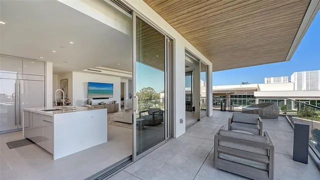 a view of a dining table and chairs in the balcony