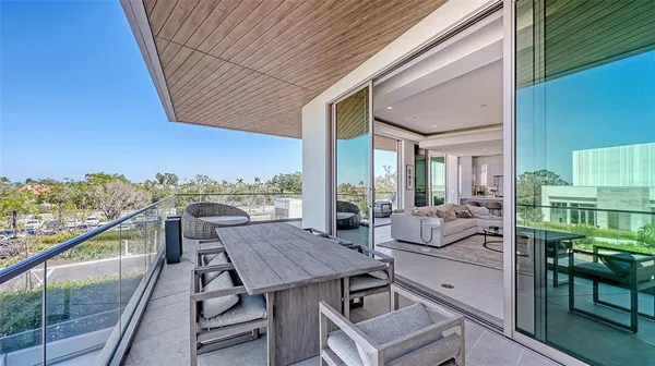 a view of a roof deck with couches and sky view