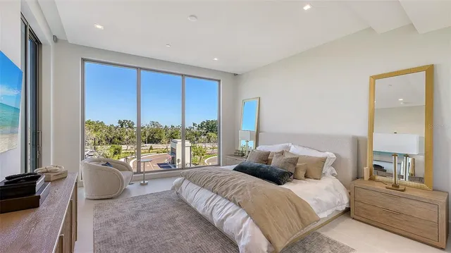 a bedroom with a large bed and a chandelier