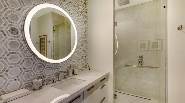 a bathroom with a granite countertop sink and a mirror