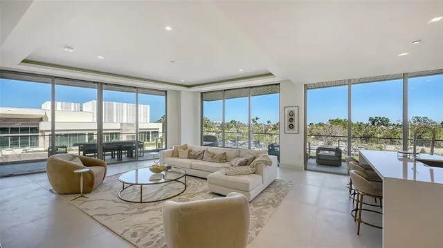 a living room with furniture kitchen and a table