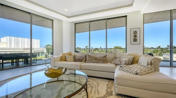 a living room with furniture fireplace and a large window