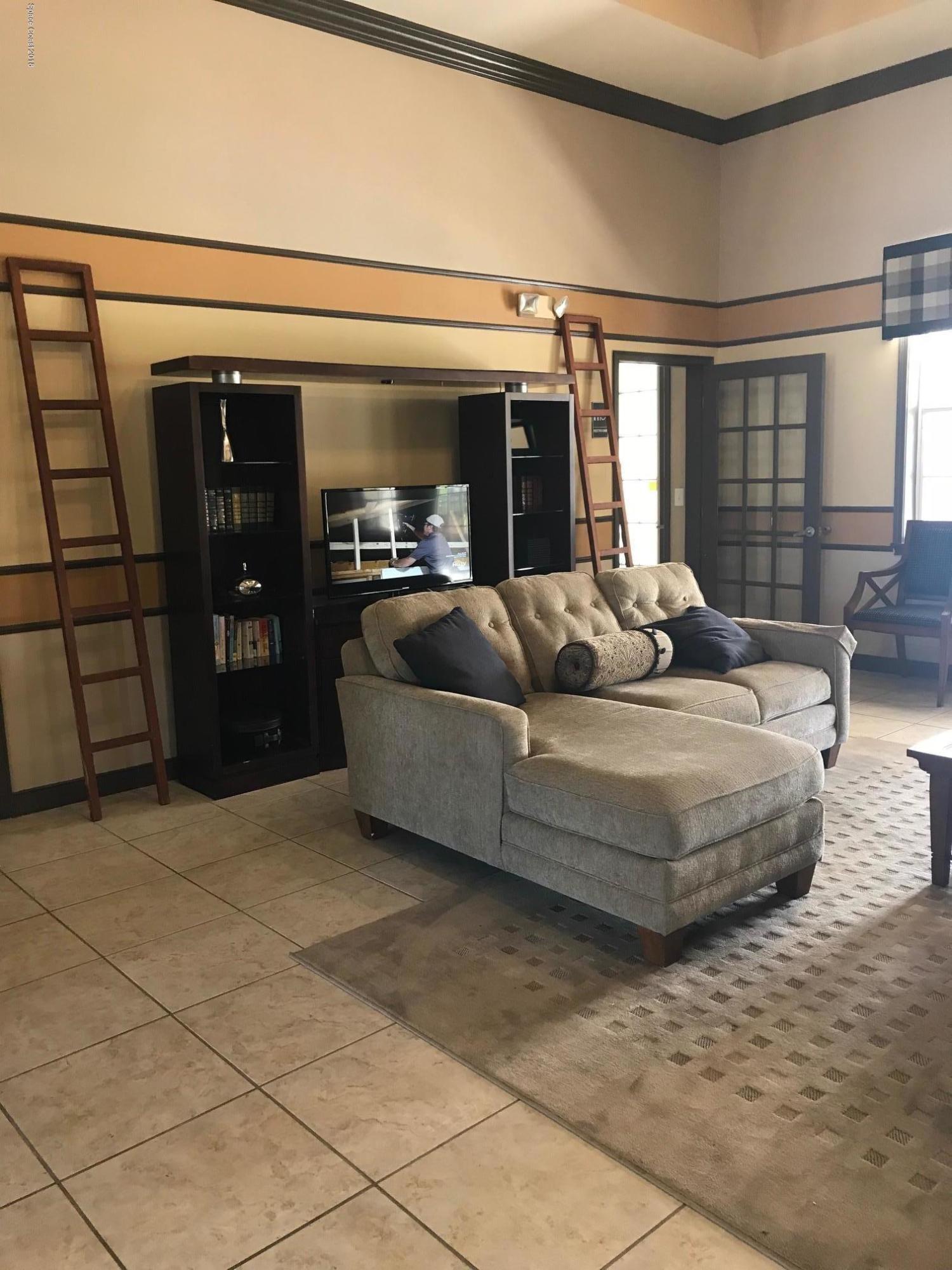 3532 D'Avinci Way, Unit 3015 Melbourne, FL 32901 - Photo 18 of 20 a living room with furniture and a flat screen tv