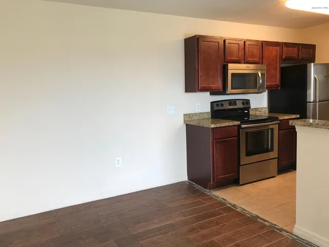 a kitchen with stainless steel appliances a refrigerator and a stove top oven