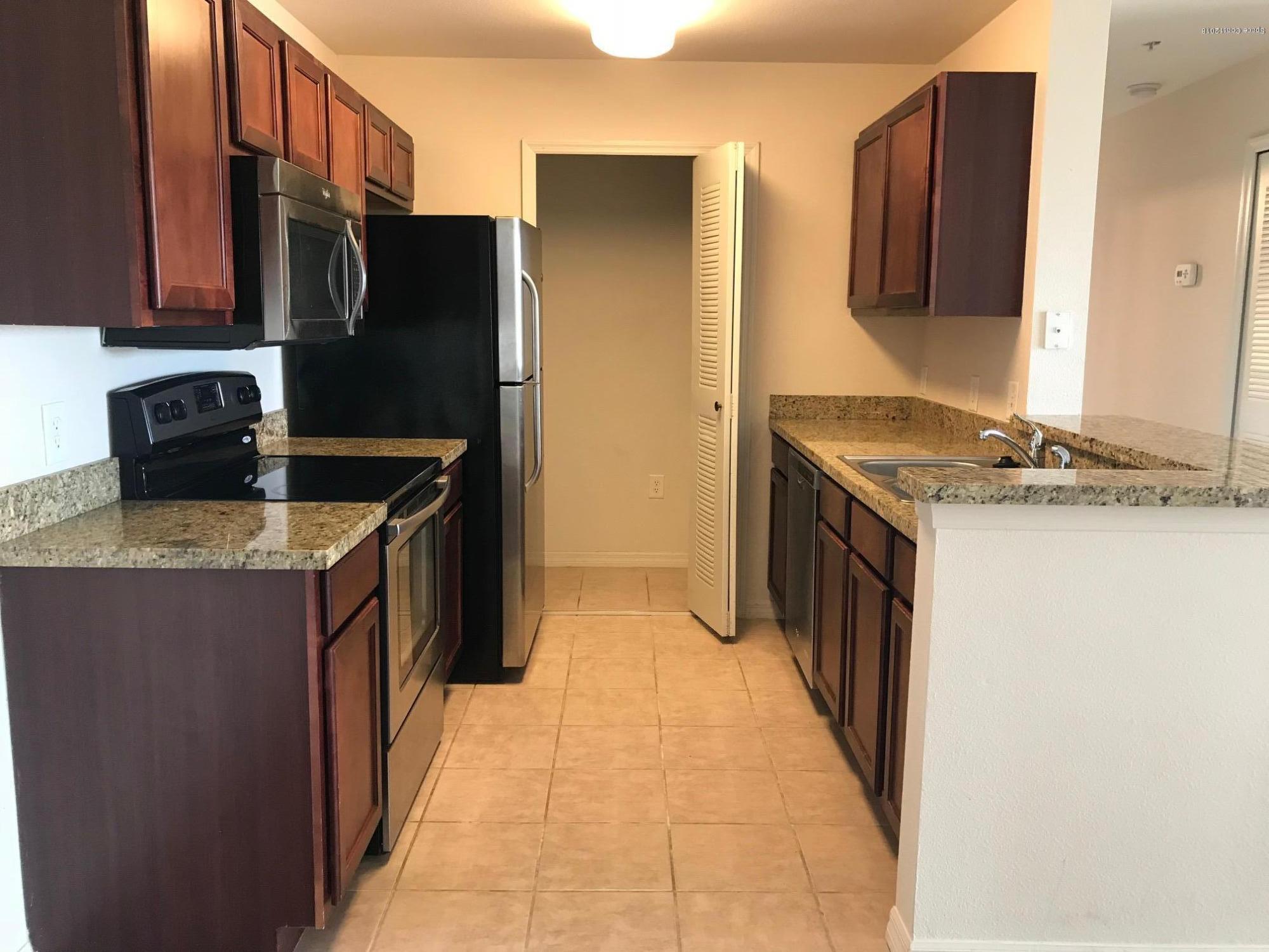 3532 D'Avinci Way, Unit 3015 Melbourne, FL 32901 - Photo 4 of 20 a kitchen with stainless steel appliances granite countertop a refrigerator and a stove