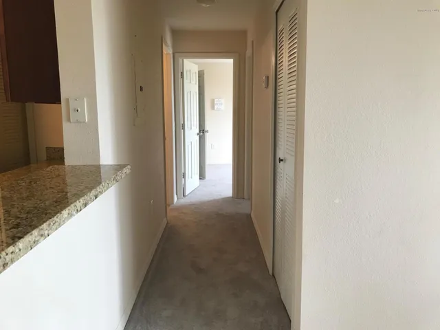 a view of a hallway with a dining room