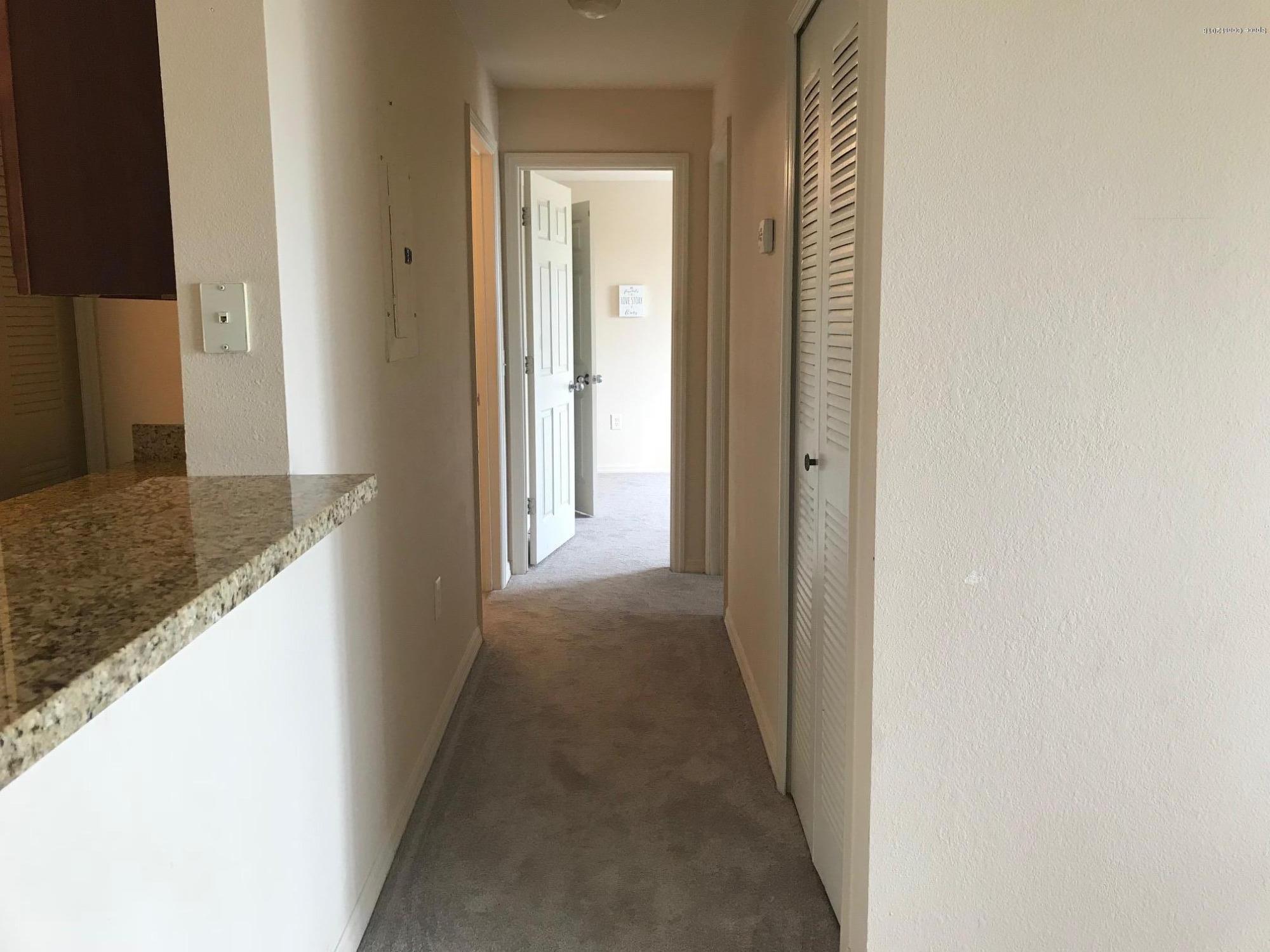 3532 D'Avinci Way, Unit 3015 Melbourne, FL 32901 - Photo 7 of 20 a view of a hallway with a dining room