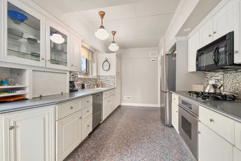 a kitchen with cabinets and window