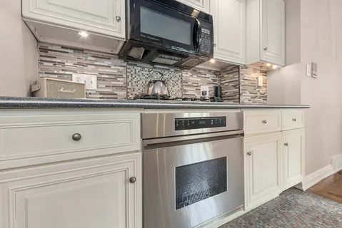 a kitchen with appliances cabinets and a counter top space