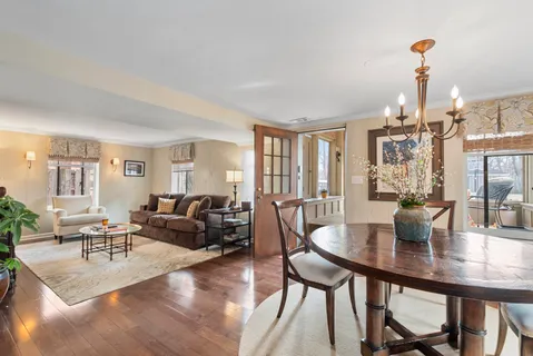 a living room with fireplace furniture and a wooden floor