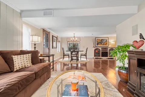 a living room with furniture and a dining table