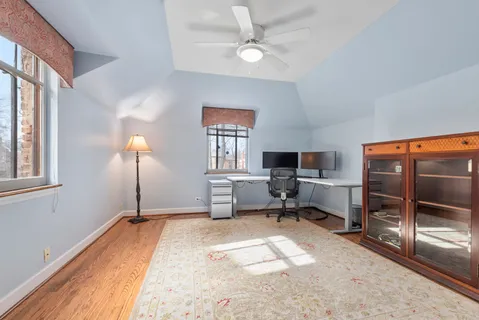 a living room with furniture a flat screen tv and a window