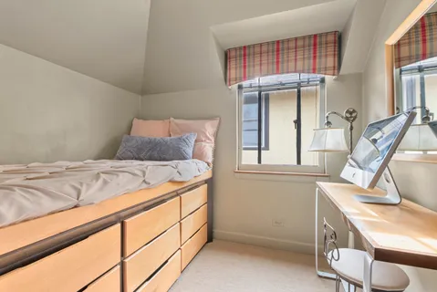 a bedroom with a bed and a window