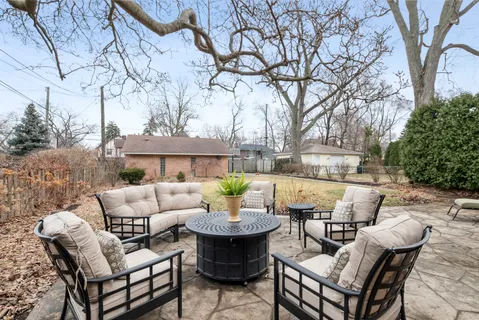 a backyard of a house with table and chairs