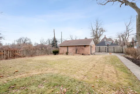 a yellow house with trees in front of it