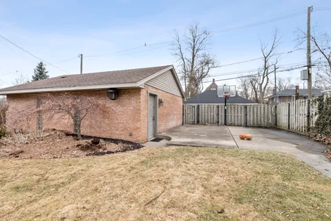 a view of a backyard with wooden fence