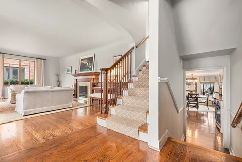 a view of a living room and dining room with wooden floor