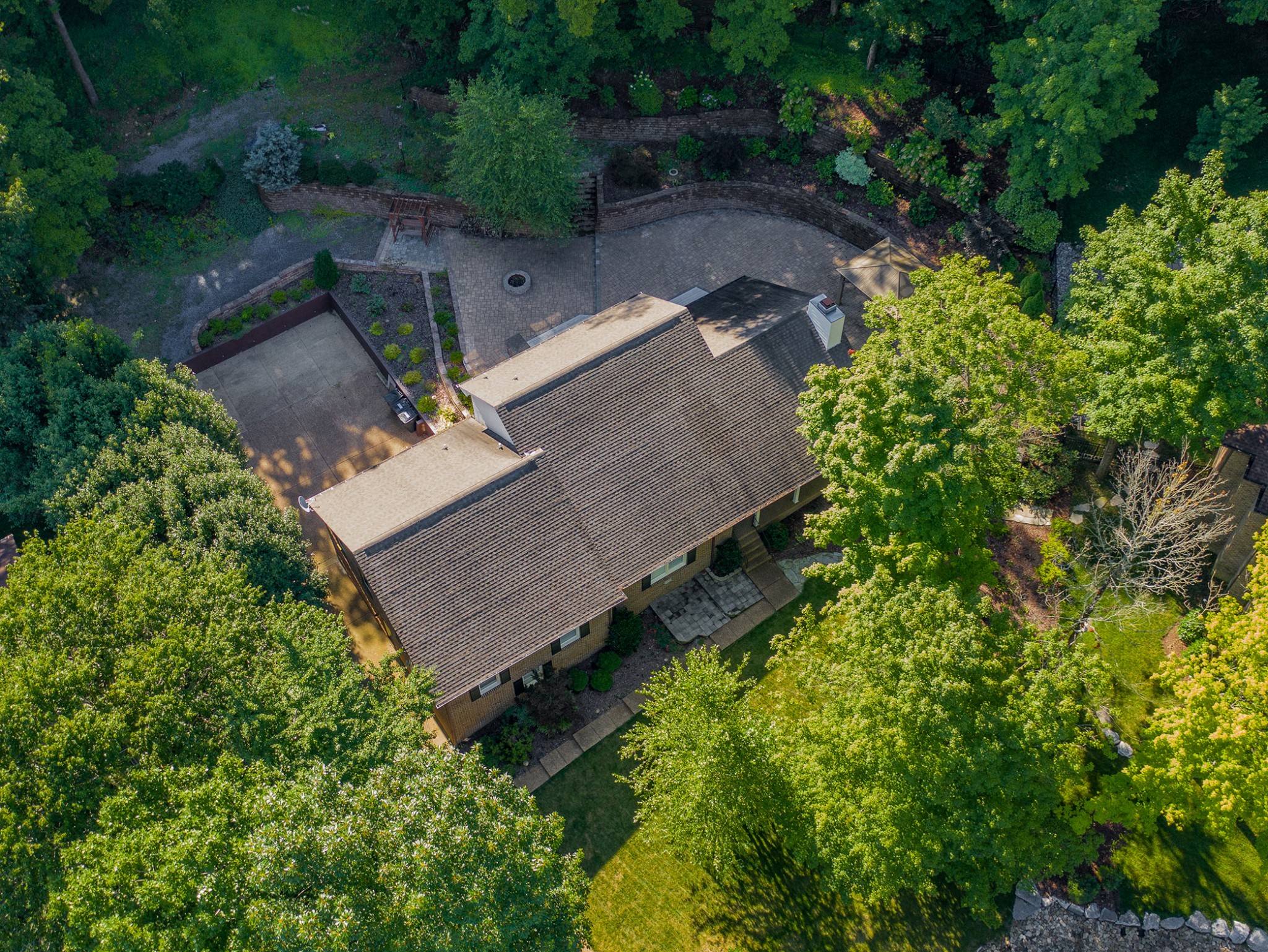 an aerial view of a house with a yard