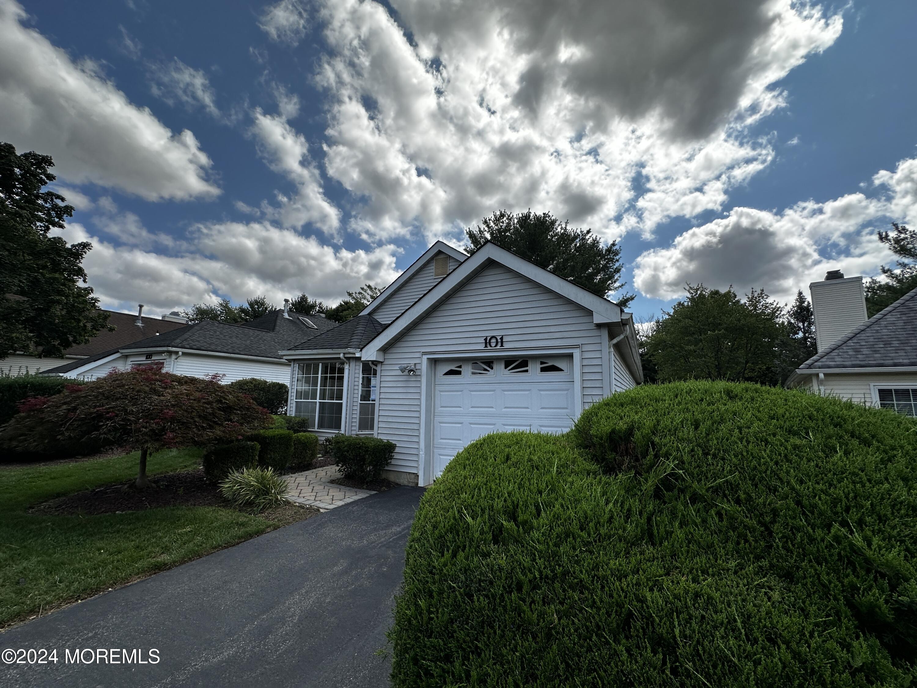 101 Almond Road Freehold, NJ 07728 - Photo 1 of 12 a front view of house with garden and trees