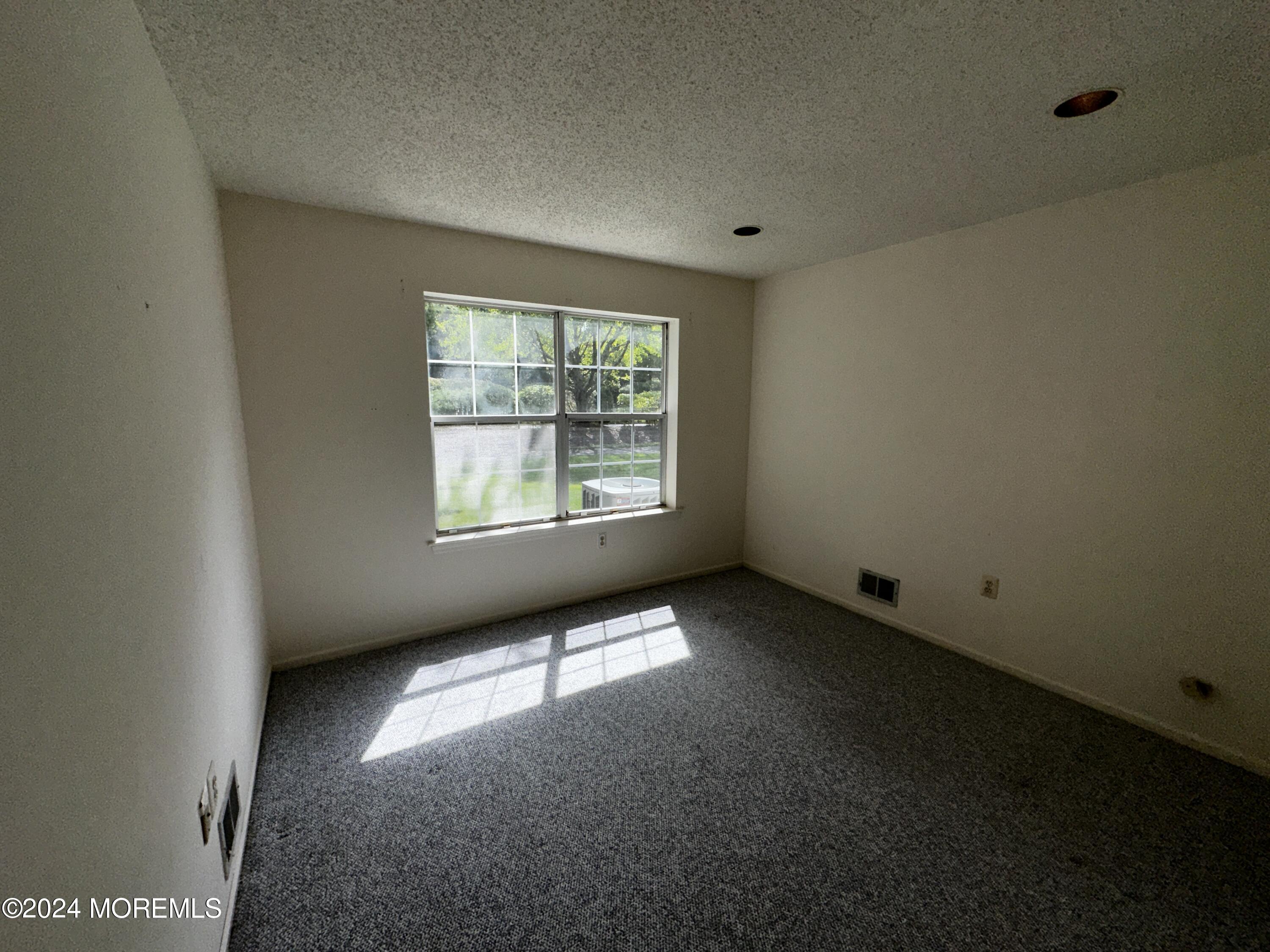 101 Almond Road Freehold, NJ 07728 - Photo 5 of 12 an empty room with a window