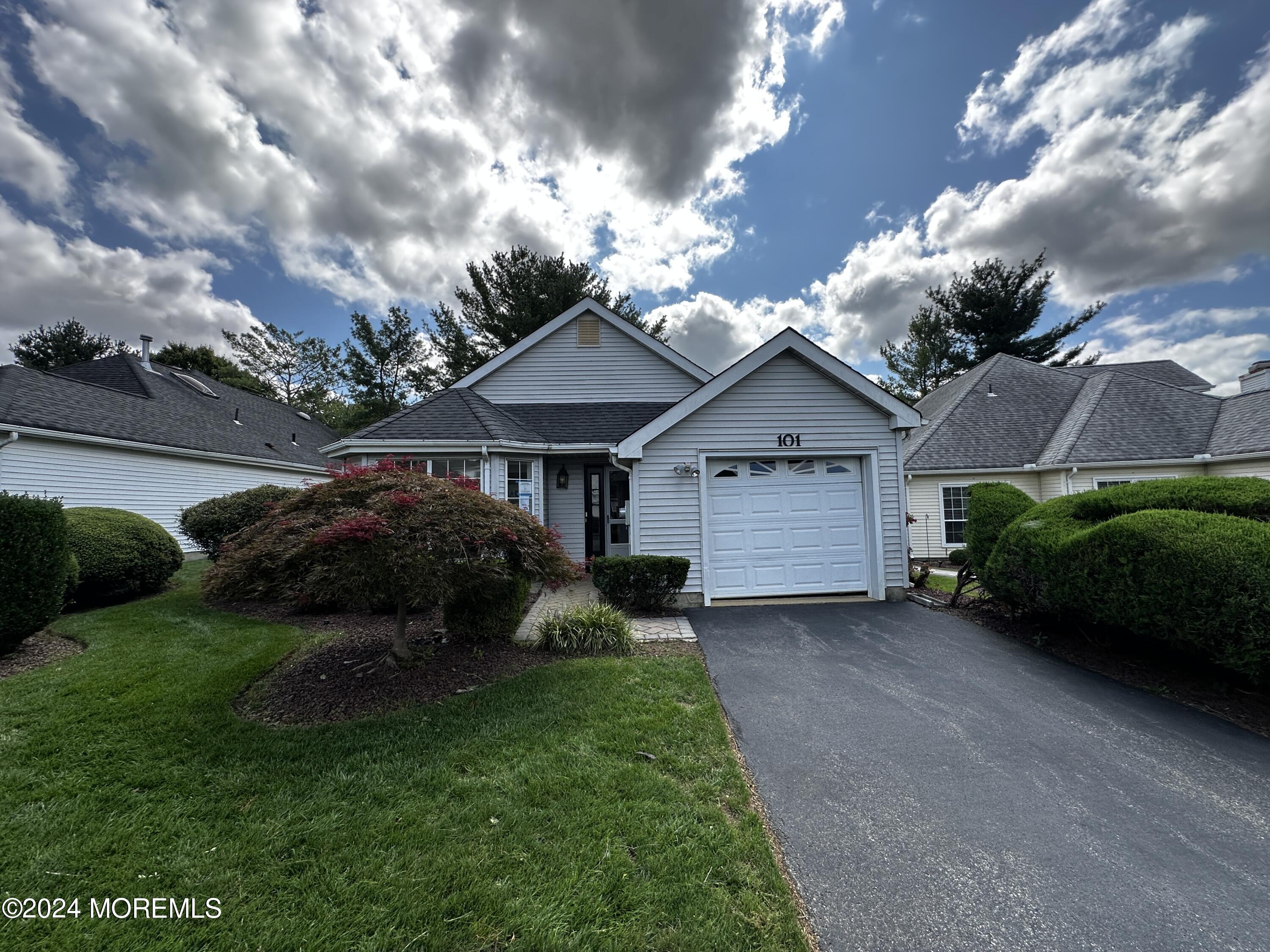 101 Almond Road Freehold, NJ 07728 - Photo 9 of 12 a view of house with garden and tall tress
