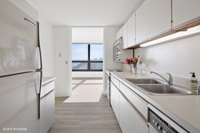 360 East Randolph Street, Unit 1002 Chicago, IL 60601 - Photo 11 of 18 a kitchen with stainless steel appliances a sink and a refrigerator