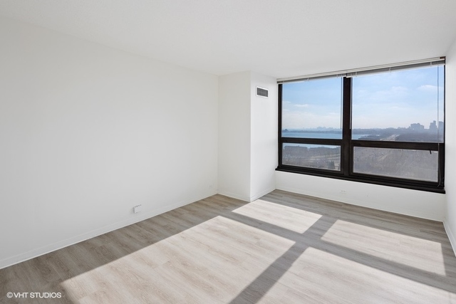 360 East Randolph Street, Unit 1002 Chicago, IL 60601 - Photo 13 of 18 a view of an empty room with a window