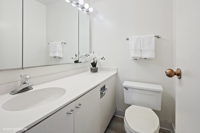 360 East Randolph Street, Unit 1002 Chicago, IL 60601 - Photo 17 of 18 a bathroom with a sink a toilet and mirror