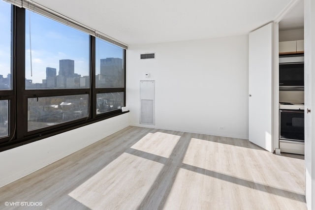 360 East Randolph Street, Unit 1002 Chicago, IL 60601 - Photo 9 of 18 a bedroom with a bed and a window