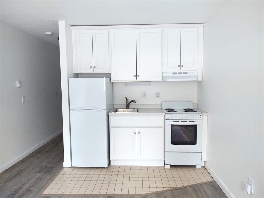 3 Leonard Road, Unit 3 Boxborough, MA 01719 - Photo 11 of 31 a kitchen with a white cabinets and white appliances