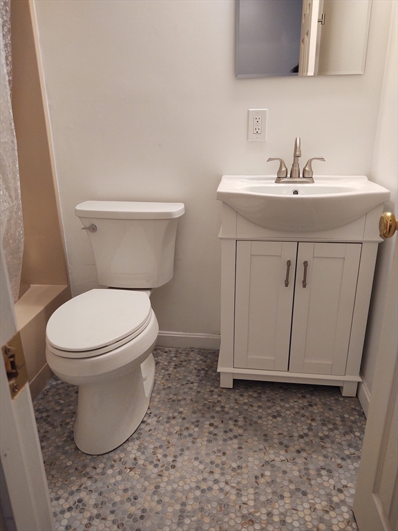 3 Leonard Road, Unit 3 Boxborough, MA 01719 - Photo 17 of 31 a bathroom with a toilet a sink and mirror
