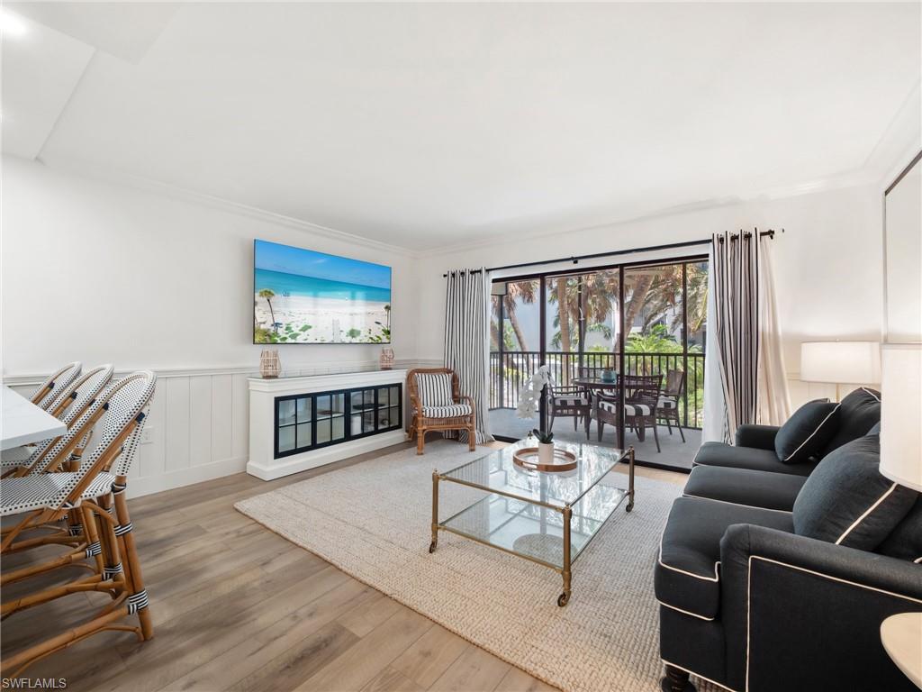 3113 Tennis Villas Captiva, FL 33924 - Photo 11 of 48 a living room with furniture a rug a lamp and a large window