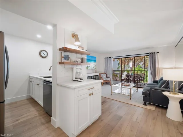 a open kitchen with sink cabinets and wooden floor