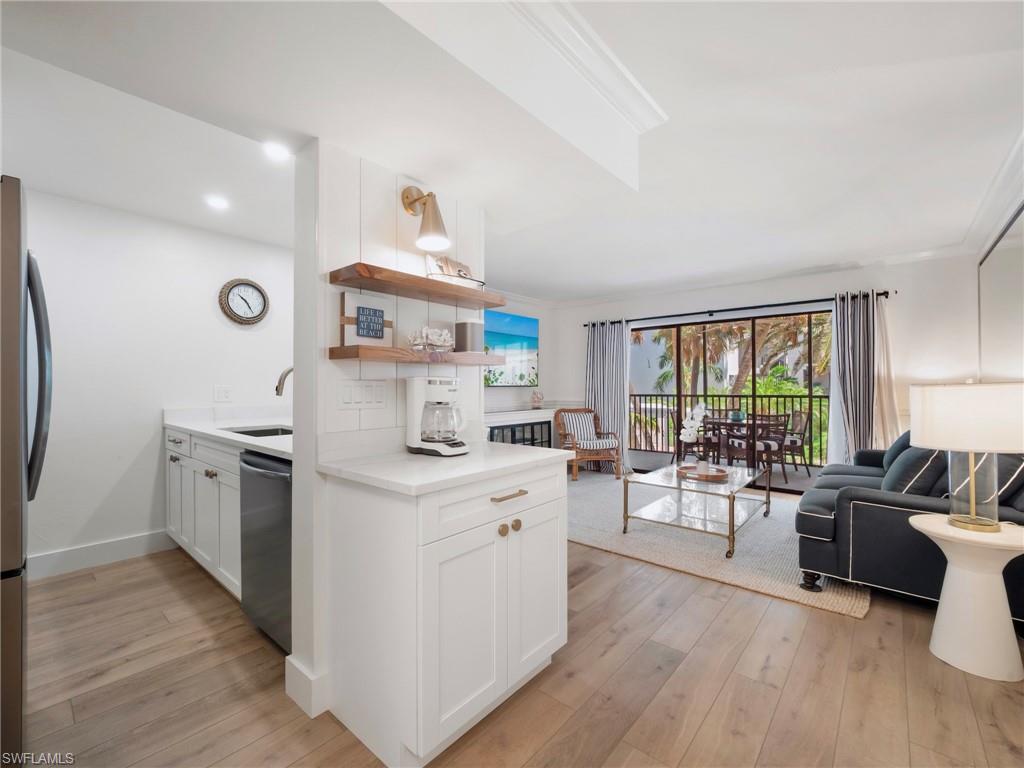 3113 Tennis Villas Captiva, FL 33924 - Photo 13 of 48 a open kitchen with sink cabinets and wooden floor