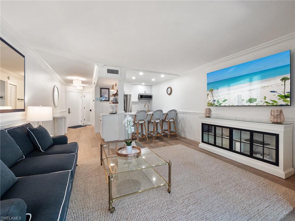 3113 Tennis Villas Captiva, FL 33924 - Photo 14 of 48 a living room with furniture a rug and kitchen view