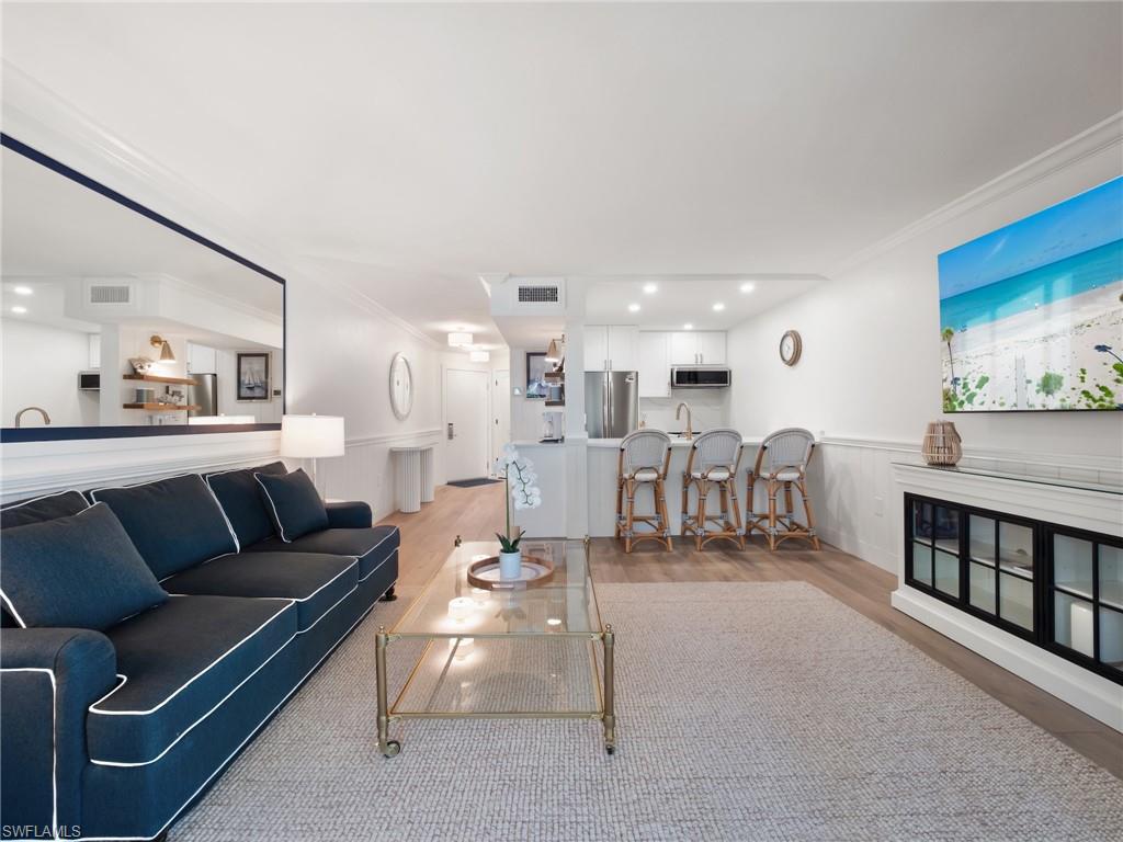 3113 Tennis Villas Captiva, FL 33924 - Photo 19 of 48 a living room with furniture and a dining table with wooden floor