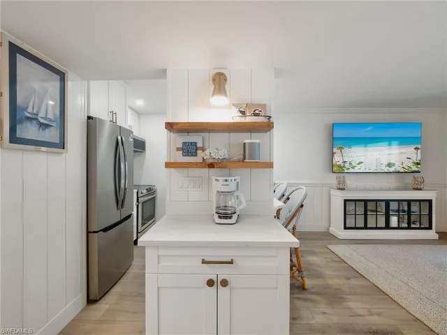 a kitchen with stainless steel appliances a refrigerator a stove a sink and a refrigerator