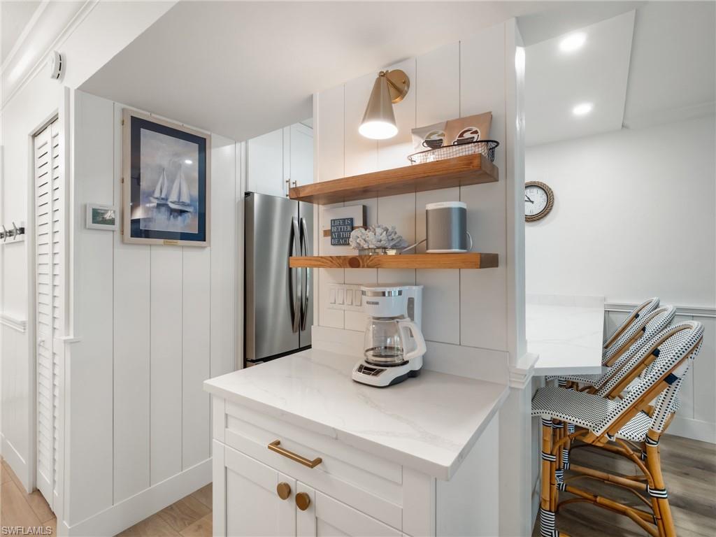 3113 Tennis Villas Captiva, FL 33924 - Photo 24 of 48 a kitchen with a refrigerator and cabinets