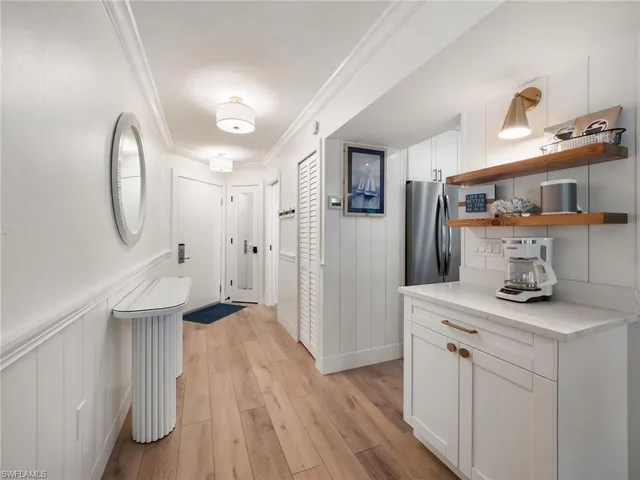 a kitchen with stainless steel appliances granite countertop a sink a stove and a wooden floors