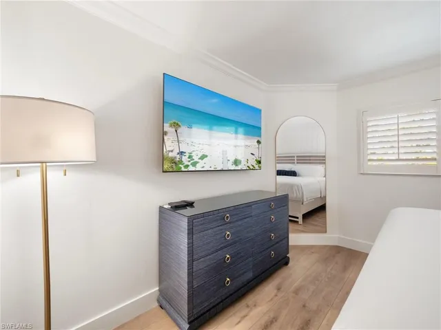 a room with a bed and a dresser