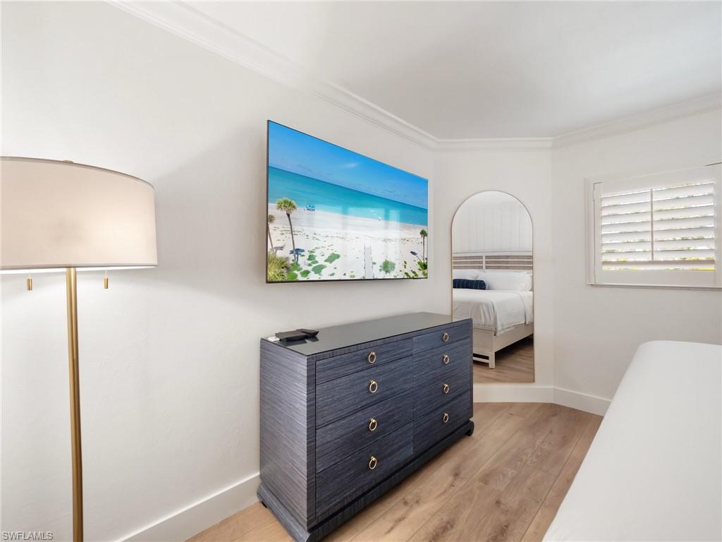 3113 Tennis Villas Captiva, FL 33924 - Photo 28 of 48 a room with a bed and a dresser