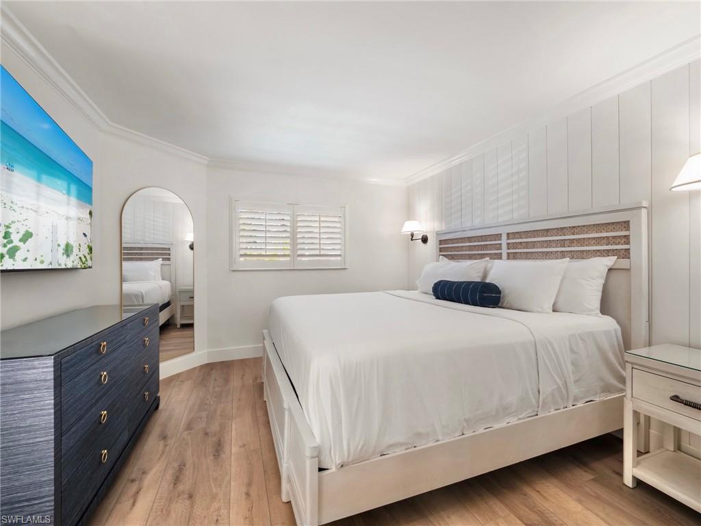 3113 Tennis Villas Captiva, FL 33924 - Photo 30 of 48 a bedroom with a bed and a dresser