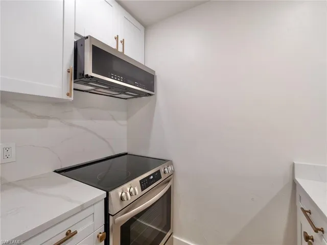 a kitchen with a stove and a microwave