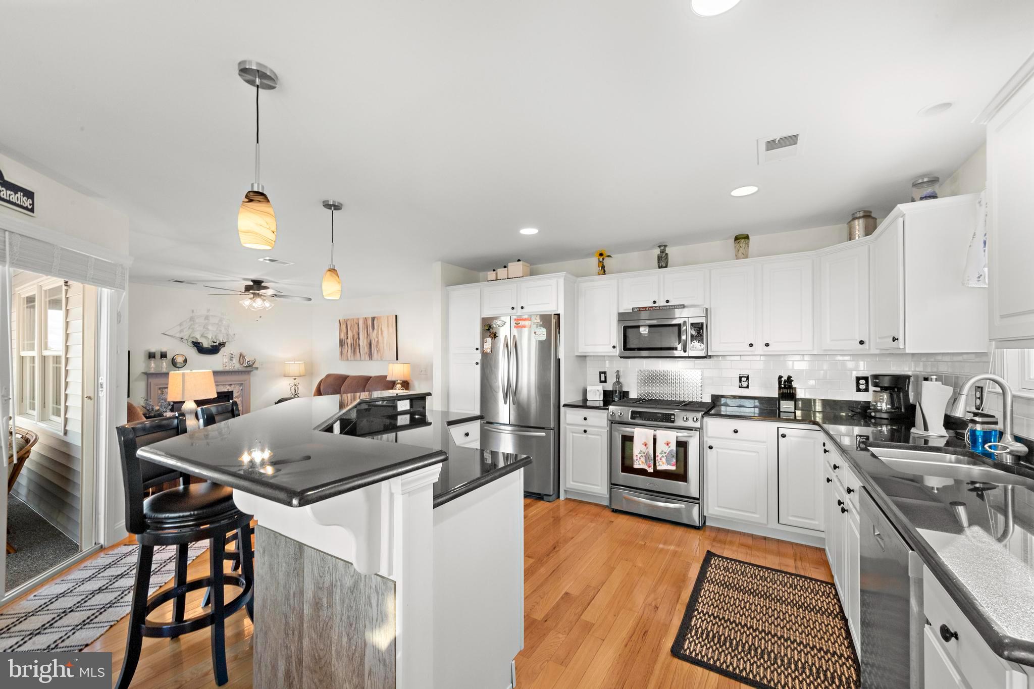 32 West Navasink Drive Little Egg Harbor, NJ 08087 - Photo 12 of 71 a kitchen with stainless steel appliances kitchen island granite countertop a sink stove and refrigerator