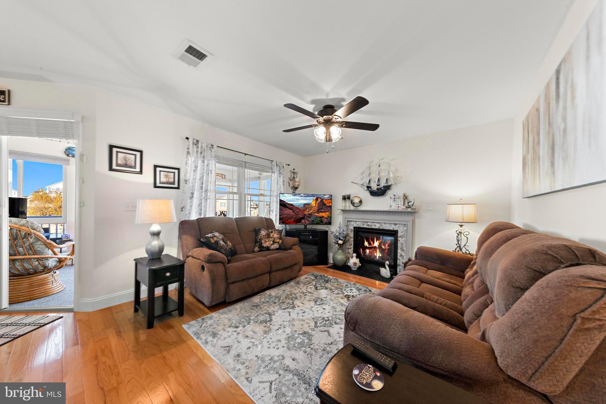 32 West Navasink Drive Little Egg Harbor, NJ 08087 - Photo 14 of 71 a living room with furniture a fireplace and a chandelier