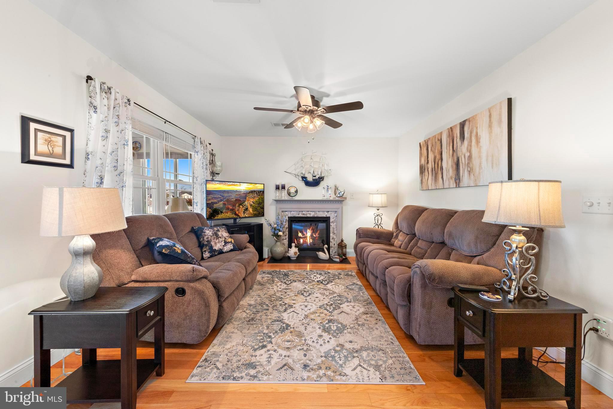 32 West Navasink Drive Little Egg Harbor, NJ 08087 - Photo 15 of 71 a living room with furniture a fireplace and a chandelier